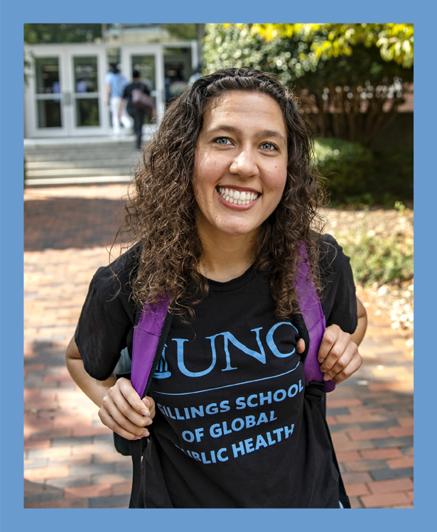 Photo of female student outside, smiling and wearing a t-shirth with UNC Gilllings School of Global Public Health logo and purple backpack. The photo has a thick Carolina Blue border around it.