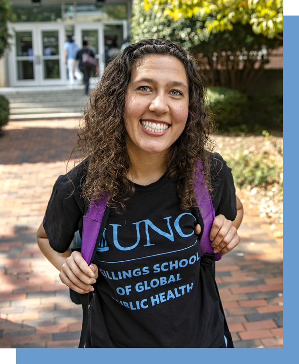 Photo of female student outside, smiling and wearing a t-shirth with UNC Gilllings School of Global Public Health logo and purple backpack. The photo has a thick Carolina Blue border around it that is offset from the photo.