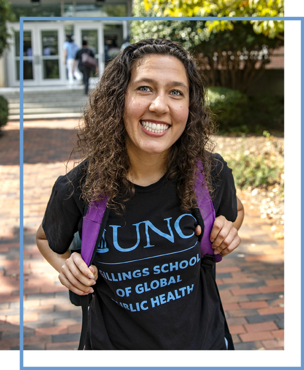 Photo of female student outside, smiling and wearing a t-shirth with UNC Gilllings School of Global Public Health logo and purple backpack. The photo has a thin Carolina Blue border around it that is offset from the photo.